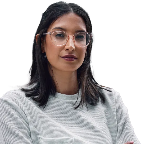 Image of woman with round-framed glasses and dark hair, wearing a gray sweater